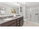 Spacious bathroom with double vanity, granite countertop, and tiled shower with glass door at 222 Explorer Dr # 271, Morrisville, NC 27560