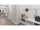Inviting entryway with bench, storage basket, coat rack, and views into the dining room at 222 Explorer Dr # 271, Morrisville, NC 27560
