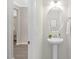 Stylish half bath with a pedestal sink, oval mirror and modern fixtures at 222 Explorer Dr # 271, Morrisville, NC 27560