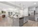 Spacious kitchen with gray cabinets, granite countertops, stainless steel appliances, and open views into the living area at 222 Explorer Dr # 271, Morrisville, NC 27560