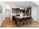 Kitchen featuring a large island with seating, granite countertops, and stylish pendant lighting at 222 Explorer Dr # 271, Morrisville, NC 27560