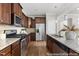 Spacious kitchen with granite countertops, stainless steel appliances, and dark wood cabinets at 222 Explorer Dr # 271, Morrisville, NC 27560