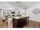 Open kitchen and living room featuring a granite island with seating and modern lighting at 222 Explorer Dr # 271, Morrisville, NC 27560