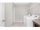 Functional laundry room with modern appliances, shelving, and tile flooring at 222 Explorer Dr # 271, Morrisville, NC 27560
