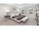 Comfortable main bedroom featuring soft carpet, decorative pillows, and large windows at 222 Explorer Dr # 271, Morrisville, NC 27560