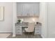 Efficient office nook with built-in desk, overhead cabinets, and granite countertop at 222 Explorer Dr # 271, Morrisville, NC 27560