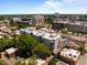 An aerial shot of the apartment building surrounded by the cityscape and lush trees on a sunny day at 222 Glenwood Ave # 714, Raleigh, NC 27603