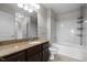Bright bathroom features a bathtub and dark wood vanity with granite counters at 222 Glenwood Ave # 714, Raleigh, NC 27603