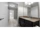 Bathroom with granite countertop vanity, mirror, and a doorway to a walk-in closet and another room at 222 Glenwood Ave # 714, Raleigh, NC 27603