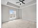 Spacious bedroom with large window and a modern ceiling fan at 222 Glenwood Ave # 714, Raleigh, NC 27603