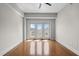 A bright bedroom with hardwood floors and natural light coming in from the balcony at 222 Glenwood Ave # 714, Raleigh, NC 27603