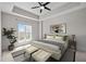 Spacious bedroom with large window and tray ceiling; has neutral decor and ample lighting at 222 Glenwood Ave # 714, Raleigh, NC 27603