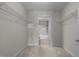 Walk-in closet with wire shelving leads to the bathroom with shower/tub combo at 222 Glenwood Ave # 714, Raleigh, NC 27603
