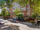 Exterior view of the building featuring outdoor seating and greenery, creating a vibrant setting at 222 Glenwood Ave # 714, Raleigh, NC 27603