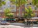 Exterior view of the 222 building, featuring outdoor seating and architectural details at 222 Glenwood Ave # 714, Raleigh, NC 27603
