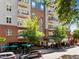 Street view of building with shops and cafes below apartments at 222 Glenwood Ave # 714, Raleigh, NC 27603