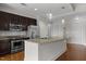 Modern kitchen featuring an island, stainless steel appliances, granite countertops, and stylish pendant lighting at 222 Glenwood Ave # 714, Raleigh, NC 27603