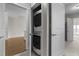 Convenient in-unit laundry featuring a stacked washer and dryer in a hallway closet at 222 Glenwood Ave # 714, Raleigh, NC 27603
