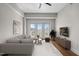 Bright living room features a comfortable couch, modern decor, and a balcony with city views at 222 Glenwood Ave # 714, Raleigh, NC 27603