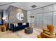 Comfortable lounge featuring a blue velvet couch, textured wall, and modern lighting at 222 Glenwood Ave # 714, Raleigh, NC 27603