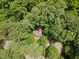 Aerial view of a tree-covered home with a brown roof surrounded by lush greenery at 24 Sunrise Pl, Durham, NC 27705