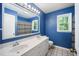 Bright blue bathroom with a double vanity, well lit with a large window, and stylish fixtures at 24 Sunrise Pl, Durham, NC 27705