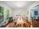 Bright dining room featuring hardwood floors, a large window, and a spacious dining table set at 24 Sunrise Pl, Durham, NC 27705