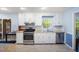 Well-lit kitchen featuring white cabinets, stainless steel appliances, and wood countertops at 24 Sunrise Pl, Durham, NC 27705