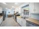 Bright kitchen featuring white cabinets, stainless steel appliances, and a view into the dining area at 24 Sunrise Pl, Durham, NC 27705