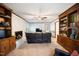 Cozy living room with a brick fireplace, dark leather furniture, and hardwood-trimmed built-in bookshelves at 24 Sunrise Pl, Durham, NC 27705