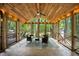 Cozy screened porch featuring wood ceiling, ceiling fan, outdoor seating, and wooded views at 24 Sunrise Pl, Durham, NC 27705