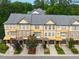 Aerial view of townhouses with neutral exterior colors, stone accents, gray roofs, and colorful awnings at 2609 Stewart Pines Dr, Raleigh, NC 27615
