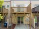 View of townhouse patios with backyard access, wooden railings, tan siding and visible AC units at 2609 Stewart Pines Dr, Raleigh, NC 27615