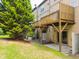 View of townhouse backyard with green grass, shade tree, privacy fence and wooden deck at 2609 Stewart Pines Dr, Raleigh, NC 27615