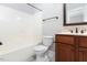 Well-lit bathroom with vanity, tiled floor, and bath tub at 2609 Stewart Pines Dr, Raleigh, NC 27615
