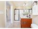 Well-lit bathroom with a glass-enclosed shower and a wooden vanity, enhanced by neutral tones at 2609 Stewart Pines Dr, Raleigh, NC 27615