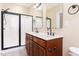 Bright bathroom features double vanity, granite counters and tiled floors adjacent to a tiled shower at 2609 Stewart Pines Dr, Raleigh, NC 27615
