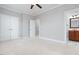 Bedroom with a view of the bathroom, closet, ceiling fan, neutral walls and plush carpeting at 2609 Stewart Pines Dr, Raleigh, NC 27615