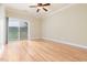 Bedroom with wood floors and natural light from the sliding glass door at 2609 Stewart Pines Dr, Raleigh, NC 27615