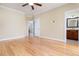 Bedroom featuring wood flooring, ceiling fan, and doorways to a closet and bathroom at 2609 Stewart Pines Dr, Raleigh, NC 27615