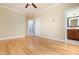 An expansive bedroom features hardwood floors and a ceiling fan and adjoins a full bath at 2609 Stewart Pines Dr, Raleigh, NC 27615