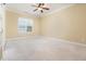 Bright bedroom features neutral walls, a ceiling fan, window with blinds, and plush carpeting at 2609 Stewart Pines Dr, Raleigh, NC 27615