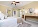Bright bedroom with a view into the ensuite, walk-in closet, ceiling fan, and plush rug, making it welcoming at 2609 Stewart Pines Dr, Raleigh, NC 27615