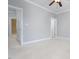 Spacious bedroom with neutral walls, ceiling fan and plush carpeting leads to other rooms at 2609 Stewart Pines Dr, Raleigh, NC 27615