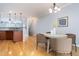 Bright dining area next to kitchen featuring hardwood floors, modern lighting, and neutral wall colors at 2609 Stewart Pines Dr, Raleigh, NC 27615