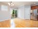 Bright dining room featuring stainless steel refrigerator, wooden cabinets, and deck access through sliding door at 2609 Stewart Pines Dr, Raleigh, NC 27615