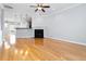 Expansive living room with hardwood floors, modern lighting, fireplace, and an open layout to the kitchen at 2609 Stewart Pines Dr, Raleigh, NC 27615