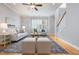 Inviting living room with hardwood floors, a ceiling fan, and neutral decor for a comfortable atmosphere at 2609 Stewart Pines Dr, Raleigh, NC 27615