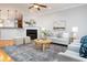 Open-concept living room flows seamlessly, boasting a fireplace, hardwood floors, and natural light at 2609 Stewart Pines Dr, Raleigh, NC 27615