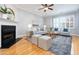 Bright living room featuring a fireplace, large windows, and stylish decor creating a welcoming space at 2609 Stewart Pines Dr, Raleigh, NC 27615